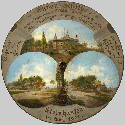 Schießscheibe der »Königlich privilegierte Feuerschützengesellschaft 'Der Bund' München« aus dem Jahr 1901; © Brigitte G. Hölscher. In den Bildausschnitten rechts und links unten ist gut das zweistöckige Gasthaus zu sehen, das bis 1961 Bestand hatte. Dahinter das Festsaalgebäude mit den zwei markanten Türmchen.